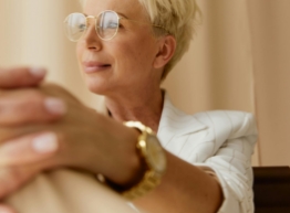 a woman with short blonde hair wearing glasses