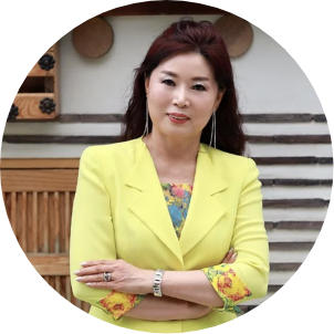 a woman in yellow jacket with arms crossed