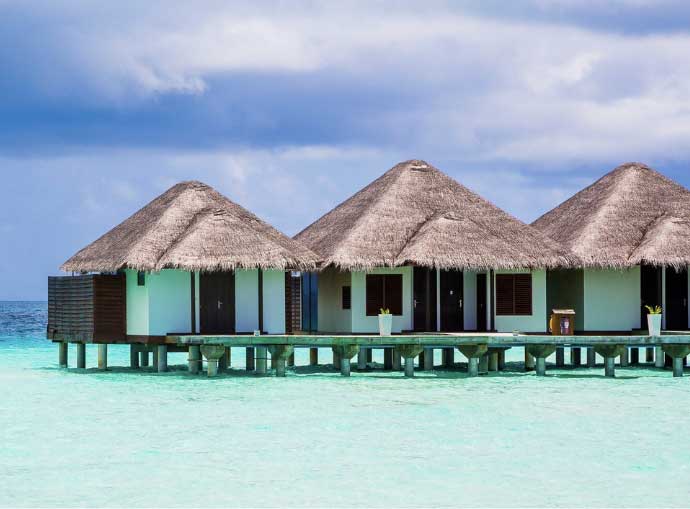 a group of houses on stilts in the water