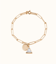 a gold chain with a triangle charm