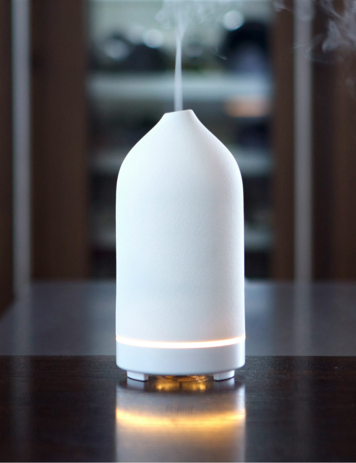 a white diffuser with mist coming out of it