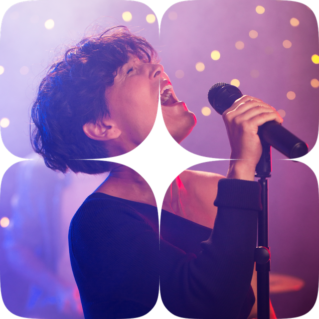 a woman singing into a microphone