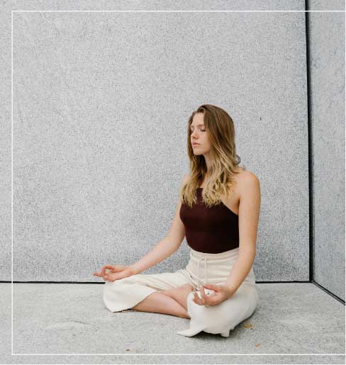 a woman sitting in a yoga pose