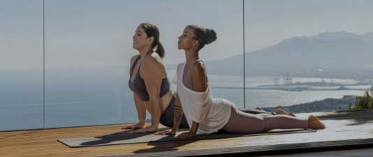 a couple of women doing yoga