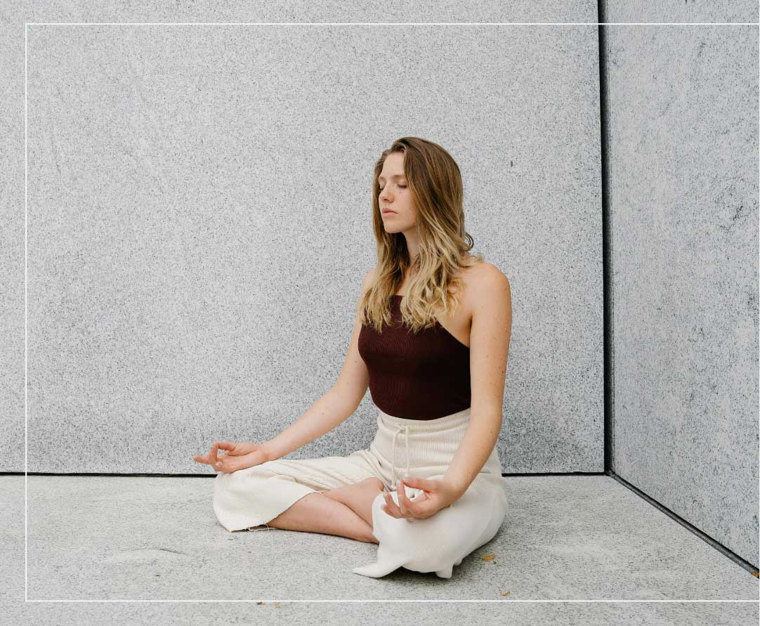 a woman sitting in a yoga pose