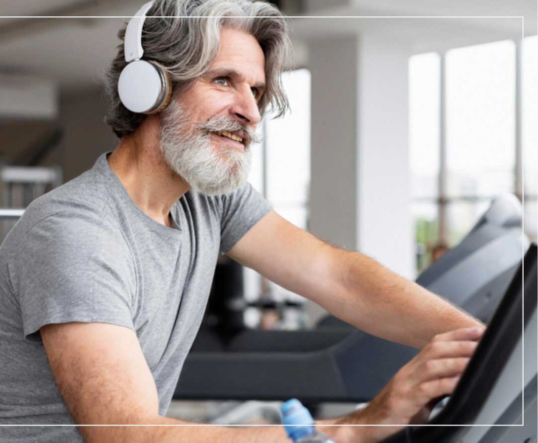 a man wearing headphones and running on a treadmill