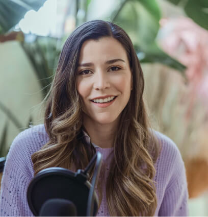 a woman with long hair and a microphone