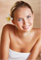 a woman smiling with a flower in her hair
