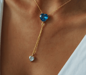 a woman wearing earrings with a flower from her ear