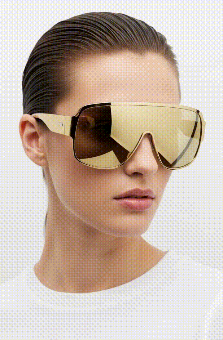 a woman wearing golden sunglasses