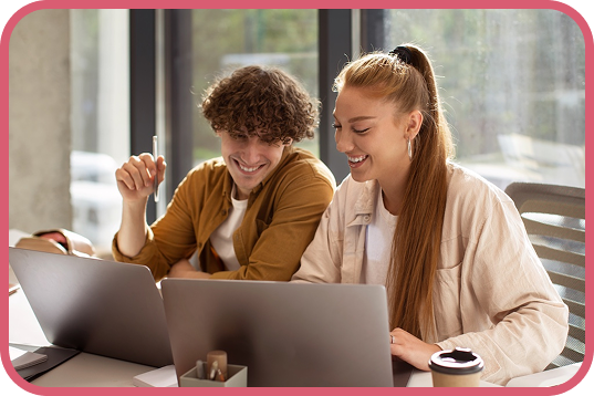 a woman sitting at a table with a laptop