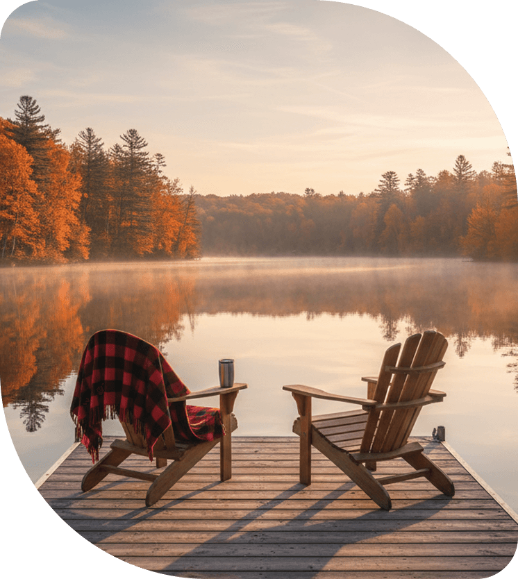 two chairs on a dock overlooking a lake