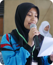 a woman wearing a head scarf holding a microphone