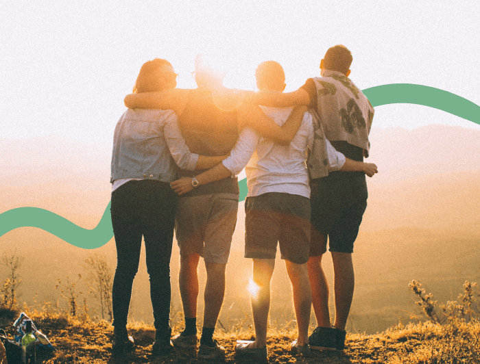 a group of people hugging on a hill