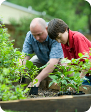 a man and boy planting a plant
