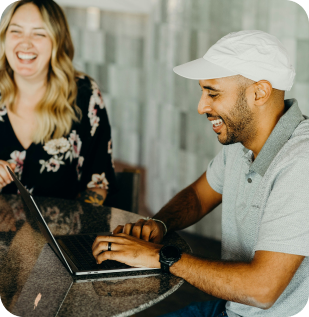 a man and woman working and laughing