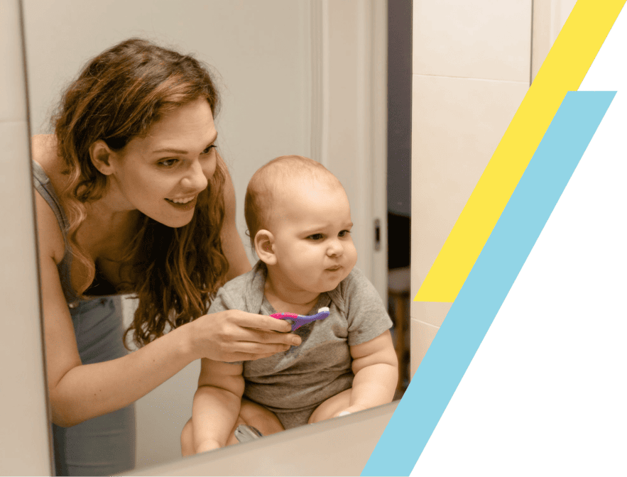 Mother brushing child's teeth