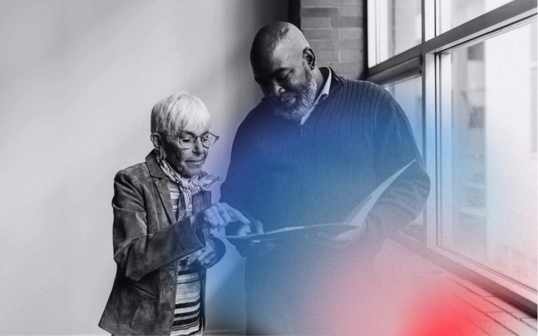 a man and woman looking at something on a tablet