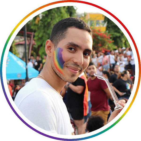 a man with rainbow face paint smiling