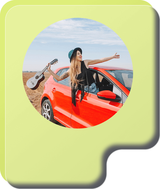 a woman holding a guitar and standing in a red car