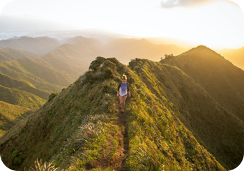 a woman walking on a mountain