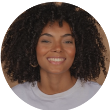 a woman with curly hair smiling