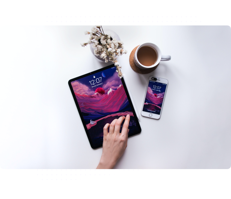 a hand touching a tablet and a cell phone