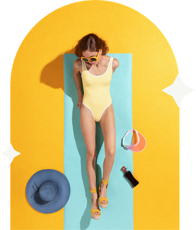 a woman lying on a mat with sunglasses and a hat