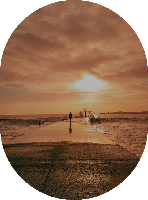 a person walking on a wet sidewalk