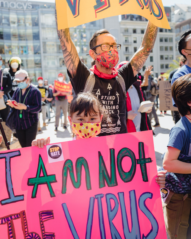 Child with I am not a virus sign
