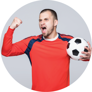 Guy cheering with a soccer ball in hand