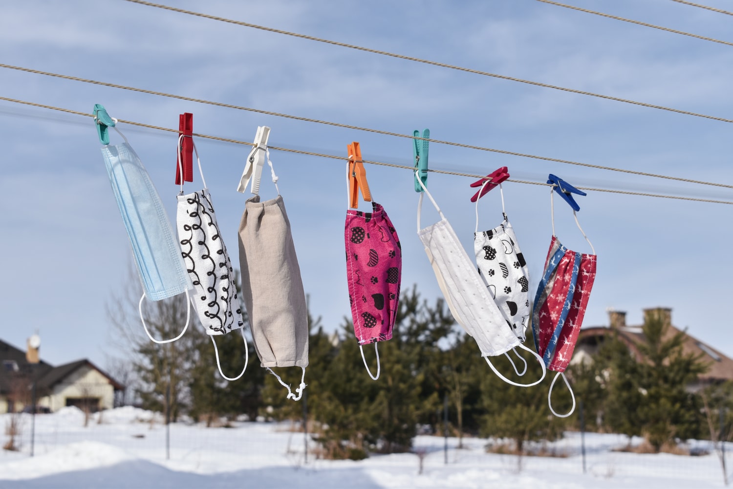 Masks hanging on a clothes line.