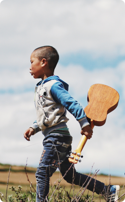 Boy running with guitar
