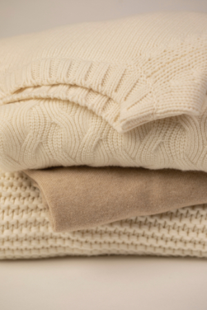 Pile of beige sweaters 