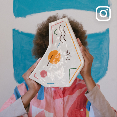 Social media image of a black female artist holding an art piece