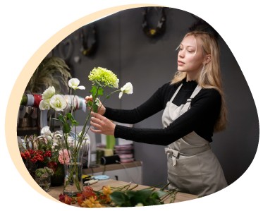 Woman Arranging Flowers In A Vase Photo