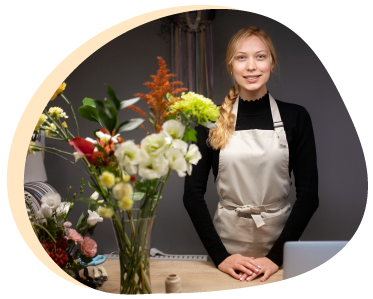 Woman Next To Vase Of Flowers