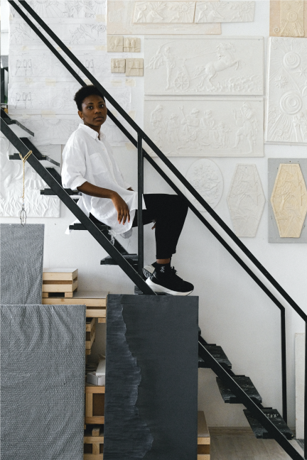 Woman Sitting On Stairs In Art Studio
