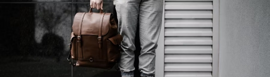 image of a men holding leather bag