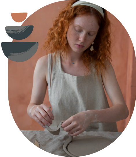 Red haired girl working with clay