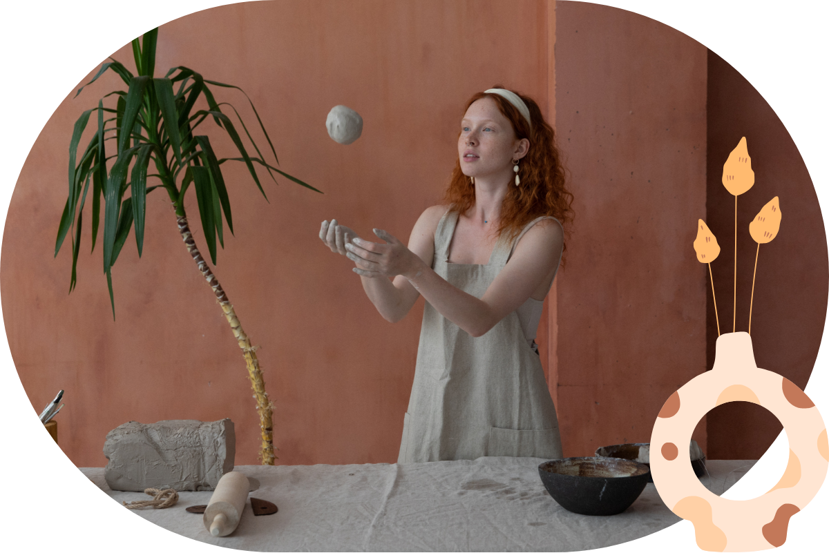 Red haired girl playing with a clay ball