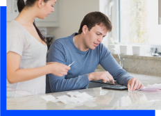 Man and Woman Looking at Receipts Photo