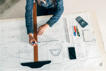 Person Drawing an Architectural Plan