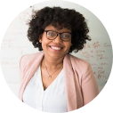 Image of an african american woman with curly hair and glasses