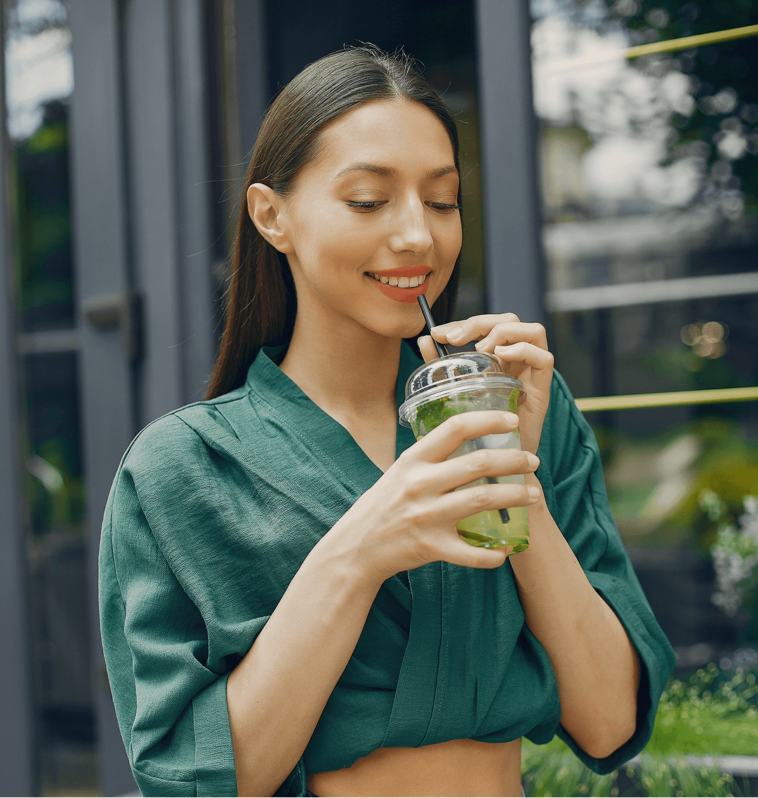 a woman drinking from a cup