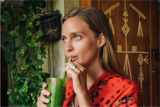 a woman drinking from a straw