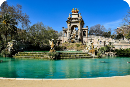 a fountain with statues in front of a building