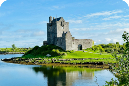 a stone building on a small island with water