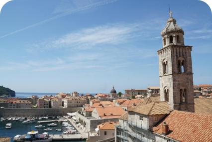 a city with a tower and boats in the water