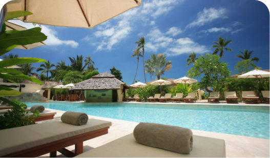 a pool with lounge chairs and umbrellas